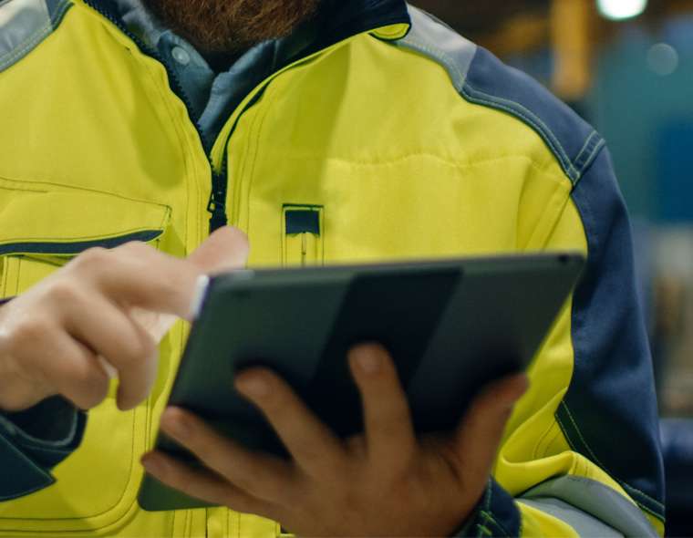 engineer with tablet looking at product details