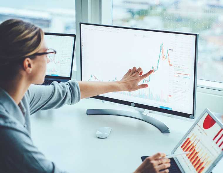 Office worker looking at business trends on the computer