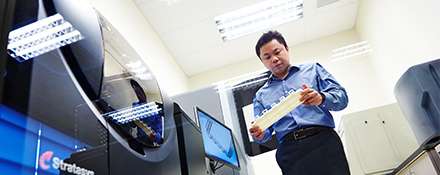 Research and development worker holding a 3D printed device