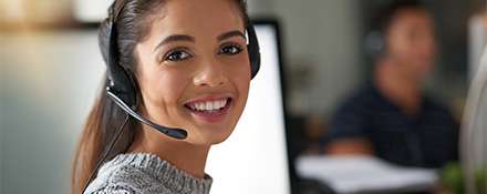 Sales representative wearing headphones, smiling