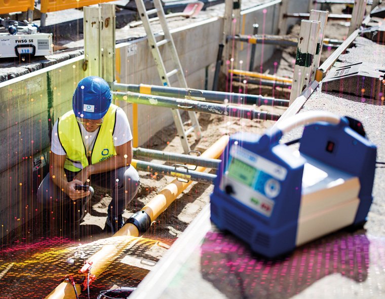 Worker fusing gas pipe with the help of Friamat 6 machine